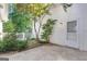 A view of the enclosed patio with mature landscaping, tiled path and an exterior door at 111 Kenton Pl, Peachtree City, GA 30269