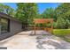 Wooden pergola patio with ample space for entertaining in this serene backyard setting at 8129 S Giles Rd, Douglasville, GA 30135