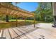 Backyard patio with wooden pergola, lush greenery, and ample space for outdoor relaxation at 8129 S Giles Rd, Douglasville, GA 30135