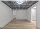 Basement with decorative ceiling and wood-look flooring at 8129 S Giles Rd, Douglasville, GA 30135