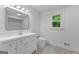Bathroom featuring a modern vanity, sink, and commode with tile flooring and a window at 8129 S Giles Rd, Douglasville, GA 30135