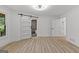 Bright bedroom featuring hardwood floors, a closet with sliding barn door and ensuite bathroom at 8129 S Giles Rd, Douglasville, GA 30135