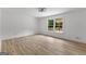 Bright bedroom featuring light wood floors and a view of the deck through a window at 8129 S Giles Rd, Douglasville, GA 30135
