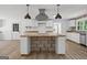 View of a modern kitchen featuring butcher block counters, white cabinets and stainless steel appliances at 8129 S Giles Rd, Douglasville, GA 30135