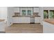 Well-lit modern kitchen features butcher block counters, stainless steel appliances, and white cabinetry at 8129 S Giles Rd, Douglasville, GA 30135