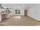 Open-concept living and dining area with hardwood floors, white walls, and stylish light fixtures at 8129 S Giles Rd, Douglasville, GA 30135