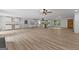 Open-concept living and kitchen area with hardwood floors, white cabinetry, and large windows at 8129 S Giles Rd, Douglasville, GA 30135