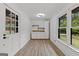 Living room featuring hardwood floors, a large window and white trim with a view of the yard at 8129 S Giles Rd, Douglasville, GA 30135