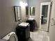 Bathroom with double sinks, tile floors, and modern fixtures in a well-lit space at 5147 Roswell Rd # 47, Atlanta, GA 30342