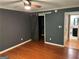 Bedroom featuring a ceiling fan, wood floors, and a barn door leading to the closet at 5147 Roswell Rd # 47, Atlanta, GA 30342