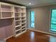 Cozy bedroom with built-in shelving and views to the outdoor landscape at 5147 Roswell Rd # 47, Atlanta, GA 30342