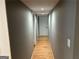 Hallway with wood flooring and fresh paint leads to various rooms at 5147 Roswell Rd # 47, Atlanta, GA 30342