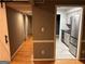 Hallway with wooden floors leads to an updated kitchen with stainless steel appliances at 5147 Roswell Rd # 47, Atlanta, GA 30342