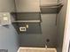 Unfinished laundry room area featuring metal shelving and gray walls at 5147 Roswell Rd # 47, Atlanta, GA 30342