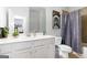 Bright bathroom with white vanity offers ample counter space and a decorative shower curtain at 3692 Wartrace Dr, South Fulton, GA 30331