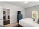 This bedroom has a TV, window, plush carpet, and ensuite bathroom at 3692 Wartrace Dr, South Fulton, GA 30331
