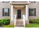 Inviting front porch with classic columns and a welcome sign, leading to a beautifully detailed front door at 3692 Wartrace Dr, South Fulton, GA 30331
