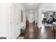 Long hallway featuring dark hardwood floors, neutral walls, and access to various rooms, creating a spacious feel at 3692 Wartrace Dr, South Fulton, GA 30331
