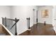 Upstairs hallway features hardwood floors, modern railings and door frames at 3692 Wartrace Dr, South Fulton, GA 30331