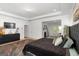 Spacious main bedroom with neutral decor, tray ceilings, a dark dresser and connected living room at 3692 Wartrace Dr, South Fulton, GA 30331