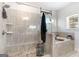 Bright bathroom featuring a glass shower and soaking tub with wood style tiling at 3692 Wartrace Dr, South Fulton, GA 30331