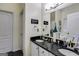 Bathroom featuring double sinks with a black countertop and decorative signage at 129 Onyx Ct, Carrollton, GA 30116