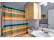 Bright bathroom with a colorful shower curtain, light wood cabinets, and a stylish vanity area at 129 Onyx Ct, Carrollton, GA 30116