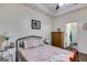 Comfortable bedroom featuring hardwood floors, a dresser, and soft lighting with easy access to the bathroom at 129 Onyx Ct, Carrollton, GA 30116