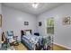 Cozy bedroom featuring a quilt-covered bed, a rocking chair, and a bright window with natural light at 129 Onyx Ct, Carrollton, GA 30116