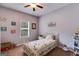 Bright bedroom featuring a white metal bed frame, neutral walls, and a window providing natural light at 129 Onyx Ct, Carrollton, GA 30116