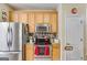 Efficient kitchen featuring stainless steel appliances, granite countertops, and warm wood cabinetry for ample storage at 129 Onyx Ct, Carrollton, GA 30116