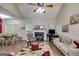 Inviting living room featuring a fireplace, hardwood floors, comfortable sofas, and natural lighting at 129 Onyx Ct, Carrollton, GA 30116