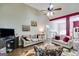 Spacious living room showcasing hardwood floors, comfortable seating, and access to the dining area at 129 Onyx Ct, Carrollton, GA 30116