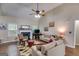 Cozy living room with a fireplace, hardwood floors, comfortable seating, and a ceiling fan at 129 Onyx Ct, Carrollton, GA 30116