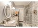 Elegant bathroom showcasing double sinks, granite countertops, and a modern glass-enclosed shower at 1091 Selwin Sw Ave, Atlanta, GA 30310
