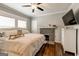 Inviting bedroom boasts hardwood floors, a cozy fireplace, and a mounted TV for entertainment at 1091 Selwin Sw Ave, Atlanta, GA 30310