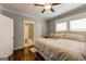 Comfortable bedroom featuring hardwood floors, a ceiling fan, and an attached bathroom for added convenience at 1091 Selwin Sw Ave, Atlanta, GA 30310