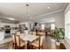 Open-concept dining area featuring hardwood floors, modern lighting, and a seamless flow to the living room at 1091 Selwin Sw Ave, Atlanta, GA 30310