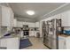 Bright and modern kitchen featuring white cabinets, stainless steel appliances, and granite countertops at 1091 Selwin Sw Ave, Atlanta, GA 30310