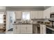 Contemporary kitchen featuring white cabinets, granite countertops, and stainless steel appliances at 1091 Selwin Sw Ave, Atlanta, GA 30310