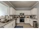 Well-lit kitchen with white cabinets, stainless steel appliances, and a granite countertop at 1091 Selwin Sw Ave, Atlanta, GA 30310