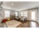 Inviting living room with a comfortable sectional sofa, hardwood floors, and ample natural light at 1091 Selwin Sw Ave, Atlanta, GA 30310