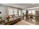 Comfortable living room with hardwood floors, a gray sectional sofa, and seamless access to the dining area at 1091 Selwin Sw Ave, Atlanta, GA 30310