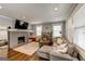 Cozy living room featuring a brick fireplace, hardwood floors, and a gray sectional sofa at 1091 Selwin Sw Ave, Atlanta, GA 30310
