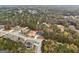 Aerial shot shows a two-story brick house in a wooded lot, complete with a well-manicured lawn at 4186 Matisse Ln, Fairburn, GA 30213