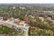 Aerial view of two-story brick house in wooded lot, complete with manicured lawn at 4186 Matisse Ln, Fairburn, GA 30213