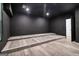 Finished basement area with tiered platform and laminate flooring, perfect for entertaining and relaxation at 4186 Matisse Ln, Fairburn, GA 30213