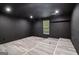 Finished basement with stylish flooring, dark painted walls, and a window for natural light at 4186 Matisse Ln, Fairburn, GA 30213