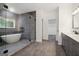 Elegant bathroom with frameless shower, freestanding tub, custom cabinets, and modern fixtures at 4186 Matisse Ln, Fairburn, GA 30213