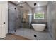 Modern bathroom featuring a glass shower, standalone tub, and stylish tile work at 4186 Matisse Ln, Fairburn, GA 30213